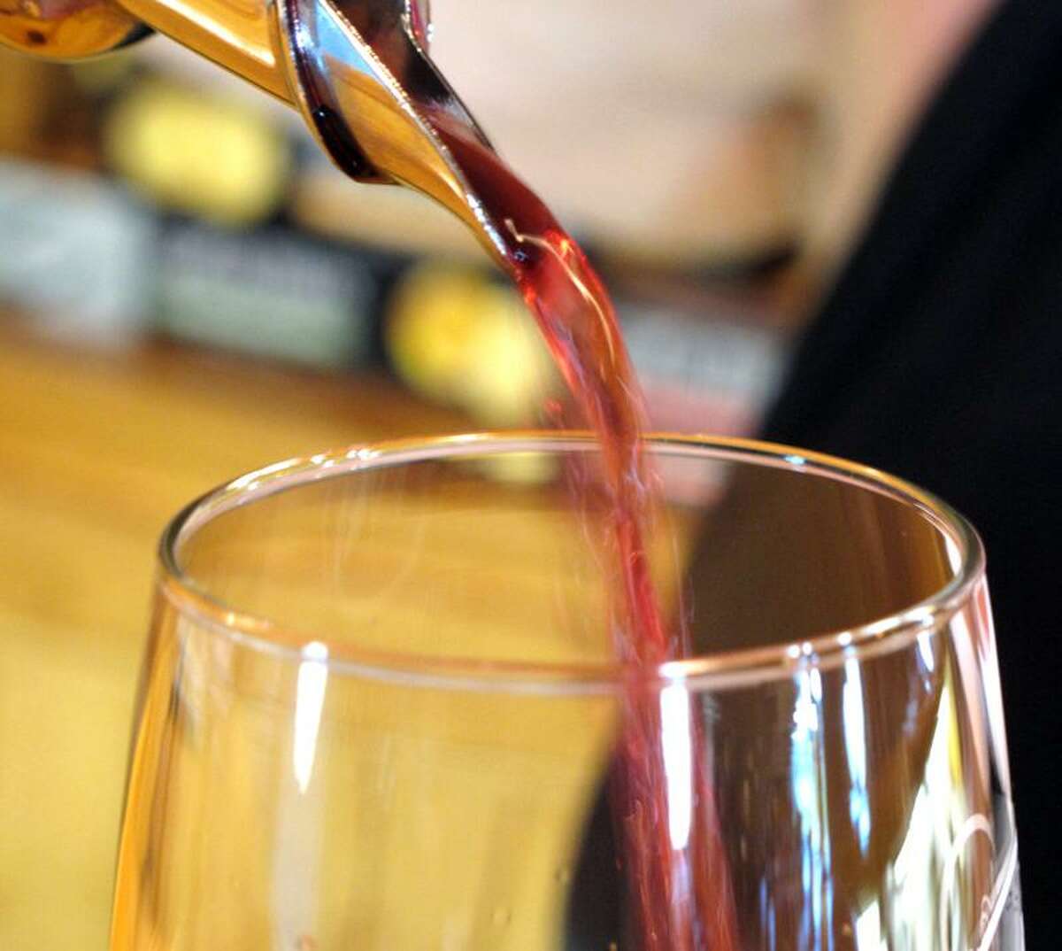 In this July 29, 2011 photo, a server pours a glass of Marquette wine into a tasting glass at the Richwood Winery in Richwood, Minn. Since it takes about three to four years for vines to mature, the Marquette wine has only recently hit store shelves.