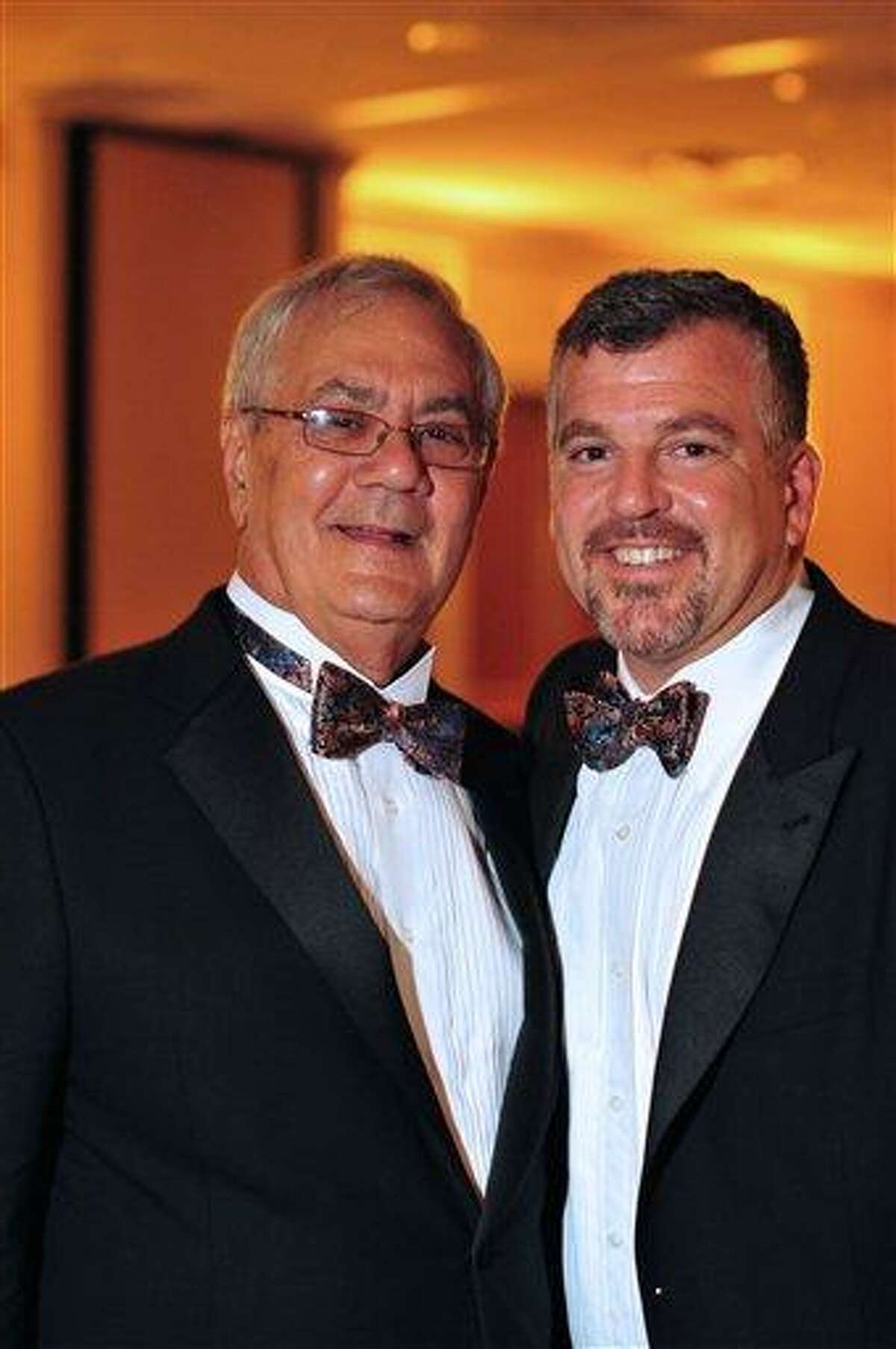 This image provided by Fotique shows U.S. Rep. Barney Frank, D-Mass., left, and Jim Ready posing at their wedding reception Saturday. Frank married his longtime partner in a ceremony officiated by Massachusetts Gov. Deval Patrick in Newton, Mass. Associated Press