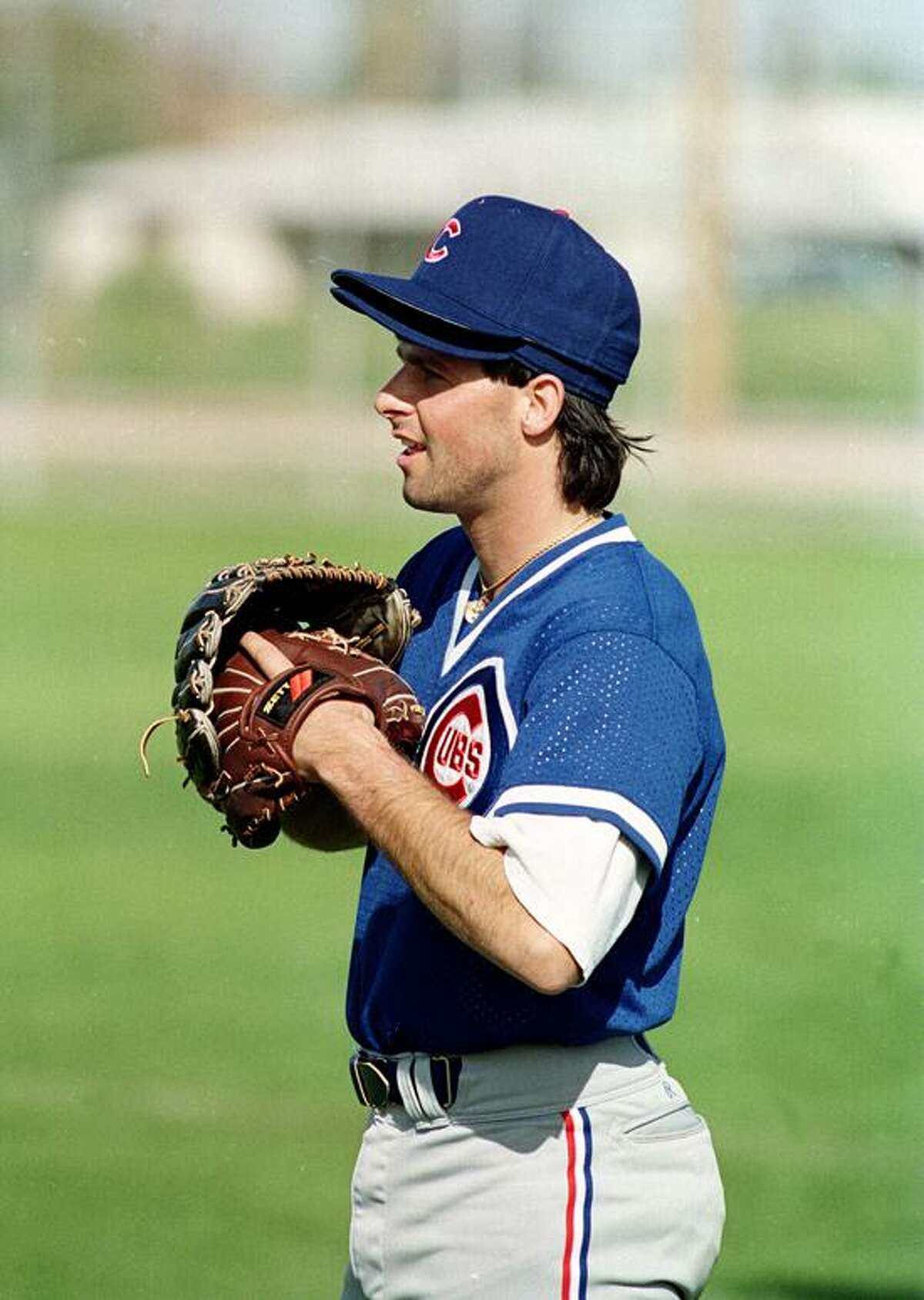 Chicago Cubs pitcher Turk Wendell wears two gloves and caps during a spring training workout at the club's facility in Mesa, Ariz., March 25, 1992. (AP Photo)