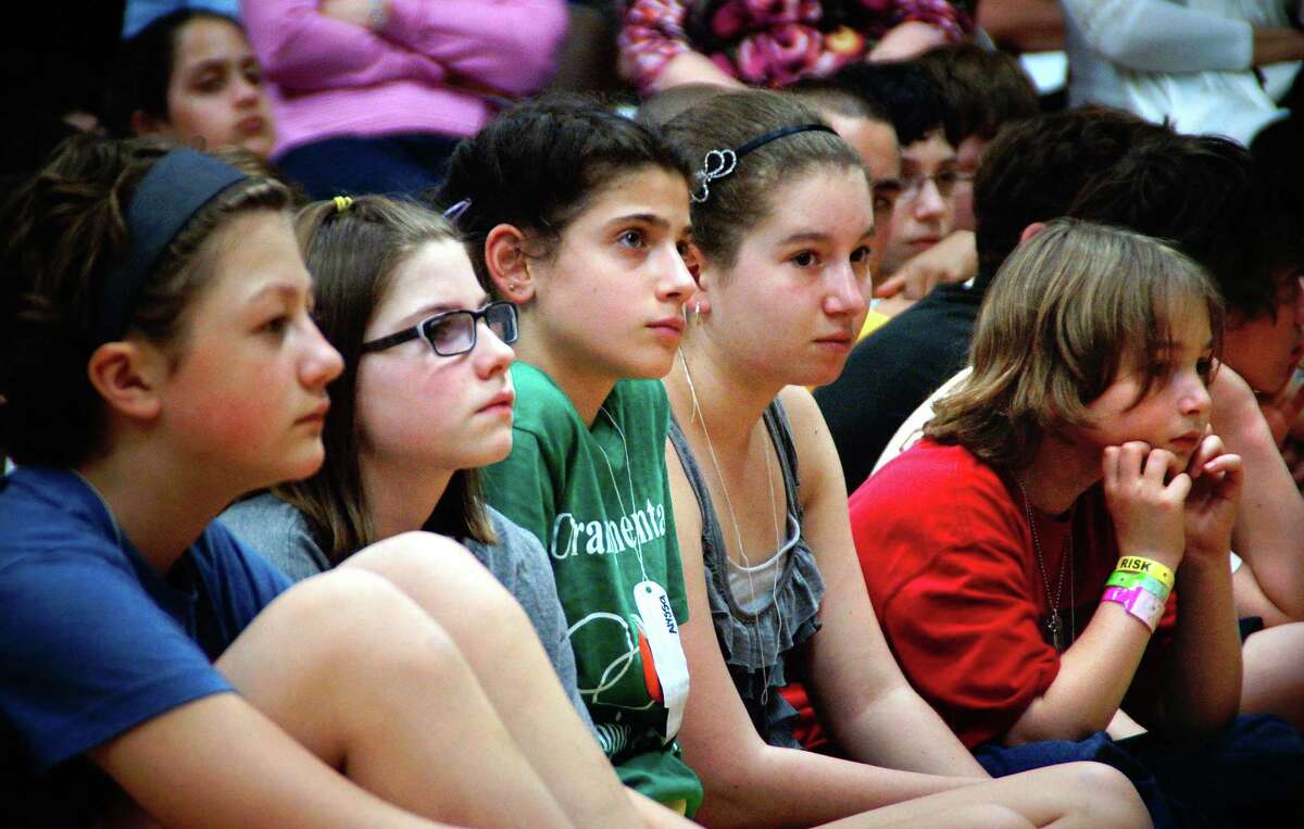 5th and 6th graders at Peck Place School in Orange listen to Holocaust survivor Anita Schorr who endured the horrors at Auschwitz as a child. Photo- Peter Casolino/New Haven Register 03/19/12