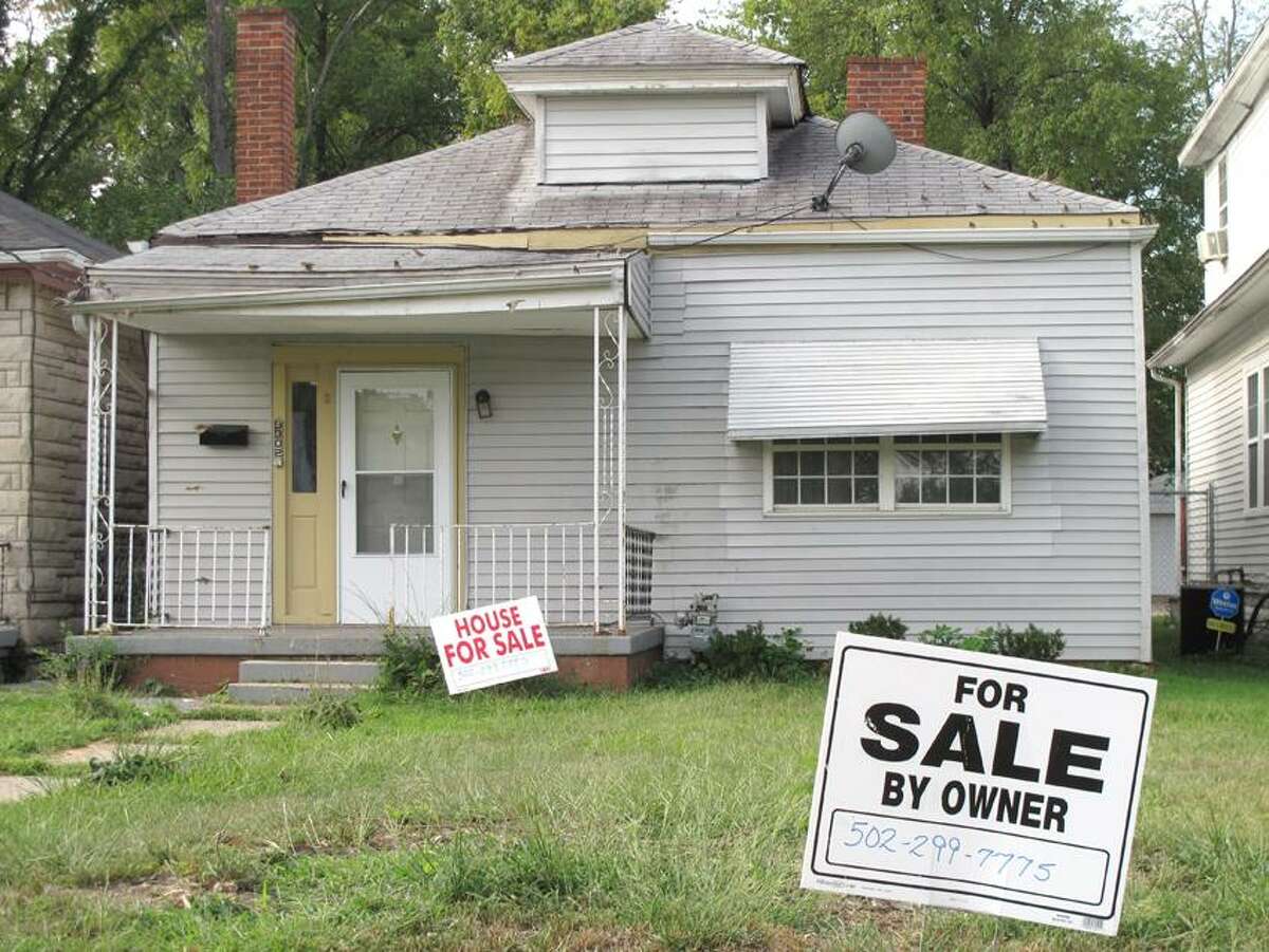 For sale signs have sprouted on the front lawn of what was Muhammad Ali's boyhood home, shown on Monday, Aug. 27, 2012, in Louisville, Ky. The owner says he is asking $50,000 for the small white house in a neighborhood in western Louisville. (AP Photo/Bruce Schreiner)(AP Photo/Bruce Schreiner)
