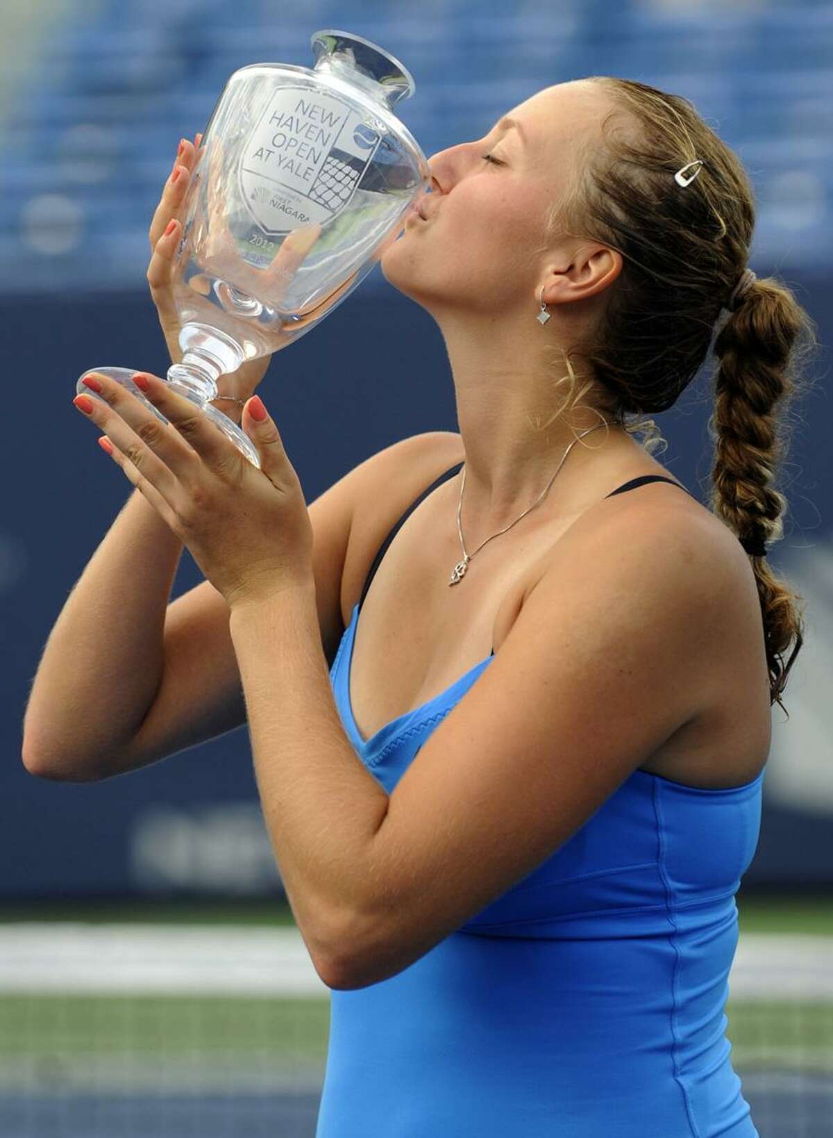 Petra Kvitova of the Czech Republic celebrates by kissing her trophy after she defeats Maria Kirilenko of Russia in two sets 7-6, 7-5 during 2012 New Haven Open at Yale WTA tennis tournament championship August 25, 2012. Photo by Bob Child / for the New Haven Register