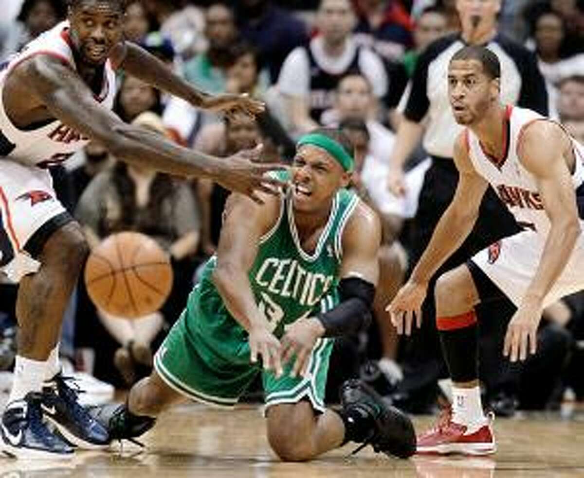 ASSOCIATED PRESS Boston Celtics forward Paul Pierce, center, passes the ball as Atlanta's Marvin Williams, left, and Jannero Pargo defend during the second quarter of Game 1 of their first-round NBA playoff series Sunday in Atlanta. The Hawks won the game 83-74.