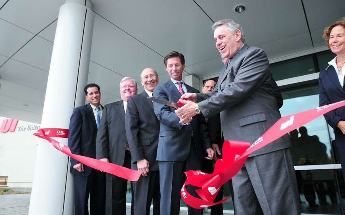 Left to right: Orange Selectman John Carangelo, Edward Drew, senior director of corporate projects for UIL Holdings Corp. and state Rep. Paul Davis watch James Torgerson, president and CEO of UIL Holdings Corp., and Anthony Vallillo, Chief Operating Officer and Executive Vice President of UIL Holdings Corp., cut a ribbon at the new United Illuminating corporate headquarters on Marsh Hill Road in Orange. At right is Orange selectman Judy Williams. Arnold Gold/Register