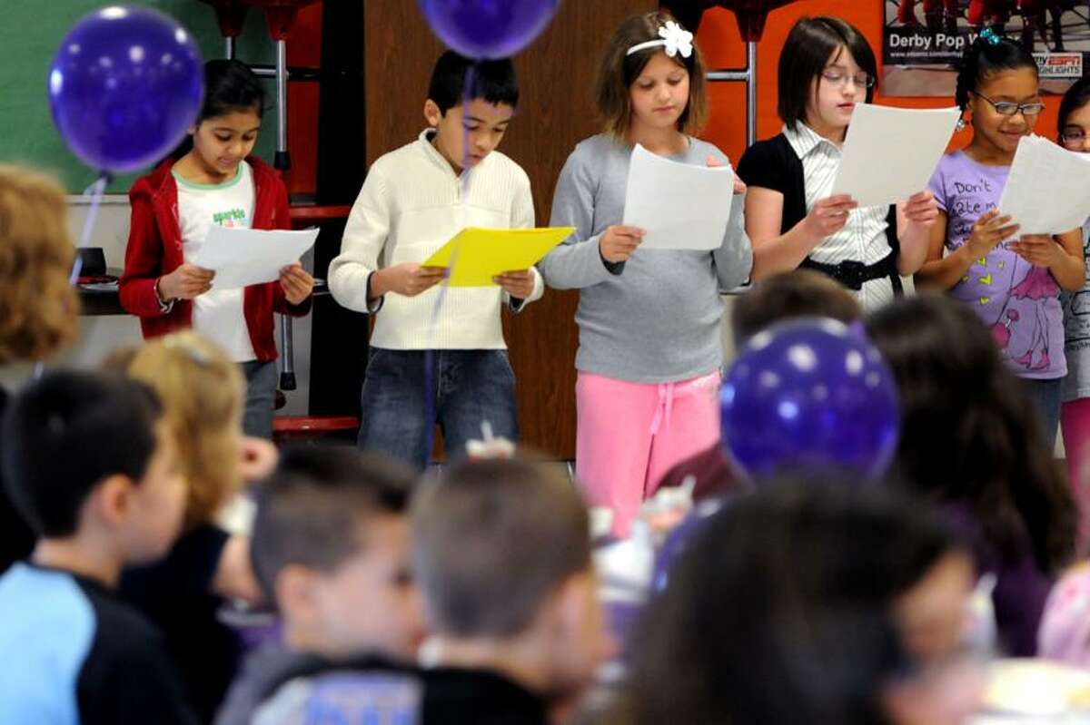 Students at Bradley Elementary School in Derby read to author Suzy Kline from a Reader's Theater excerpt. Peter Hvizdak/Register