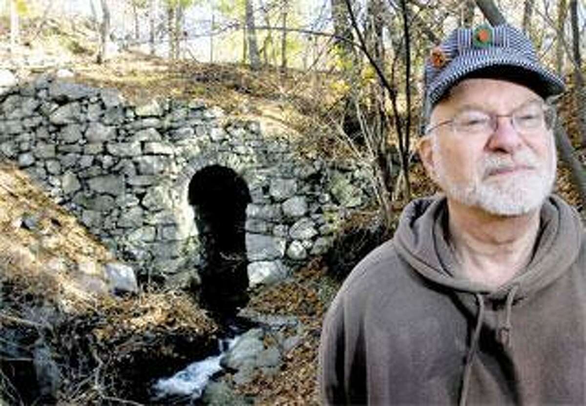 Bob Belletzkie of Prospect hunts for remnants of Connecticut railroads. This culvert was built over Davis Brook in Derby for the New Haven & Derby Railroad line. He posts his discoveries on TylerCityStation. info. (Arnold Gold/Register)