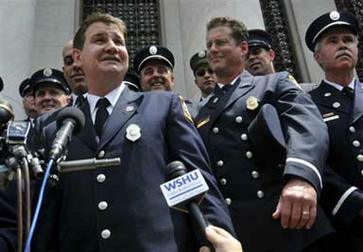 Frank Ricci, left, lead plaintiff in the the "New Haven 20" firefighter reverse discrimination case speaks to the media outside of Federal Court in New Haven, Conn., Monday June 29, 2009. The Supreme Court ruled in a 5-4 decision that white firefighters in New Haven, Conn., were unfairly denied promotions because of their race, reversing a decision that high court nominee Sonia Sotomayor endorsed as an appeals court judge. (AP Photo/Jessica Hill)