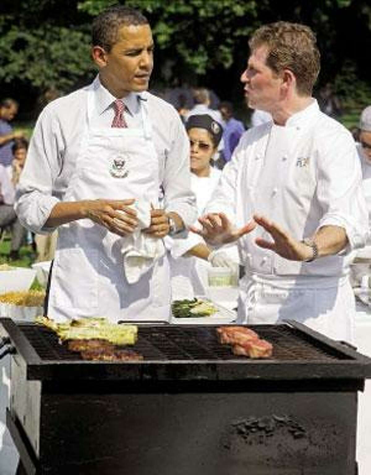 Even President Barack Obama needed a few grilling tips from chef Bobby Flay shown here on the South Lawn of the White House. (Haraz N. Ghanbari/Associated Press)