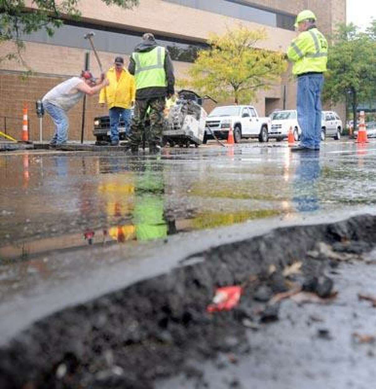 Connecticut DOT, New Haven Public Works Department and a private contractor rip up the road on Union Ave. in front of the Police department building and near Union Station Friday trying to find the cause of road heaves and flooding on Union Ave. (Peter Hvizdak/Register)