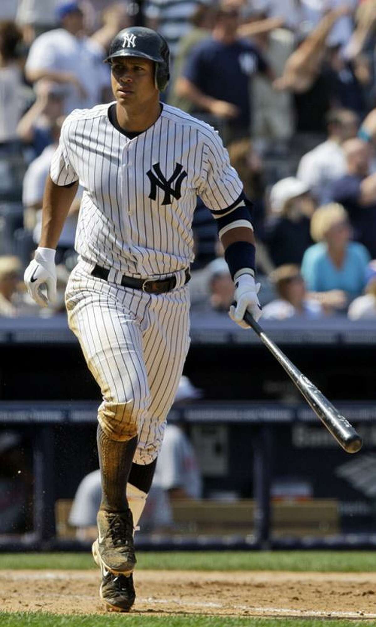 Alex Rodriguez takes a look into the Yankees' dugout after hitting a grand slam in the seventh inning of New York's 11-2 win over Cleveland on Monday. (Associated Press)