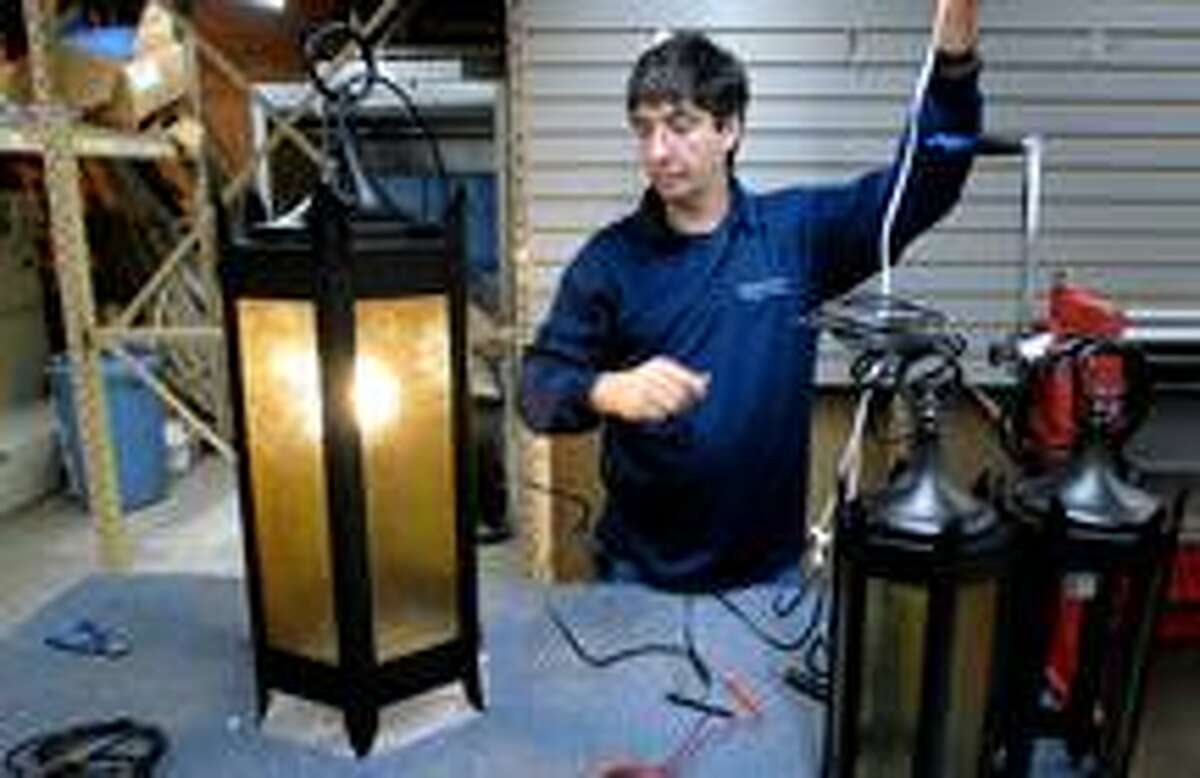 Kevin Stankiewicz tests one of the gothic style pendants restored by Grand Light in New Haven on 3/12/2010 for Geyser Hall at Old Faithful Lodge in Yellowstone National Park. The light fixtures date back to 1918.Photo by Arnold Gold AG0355D