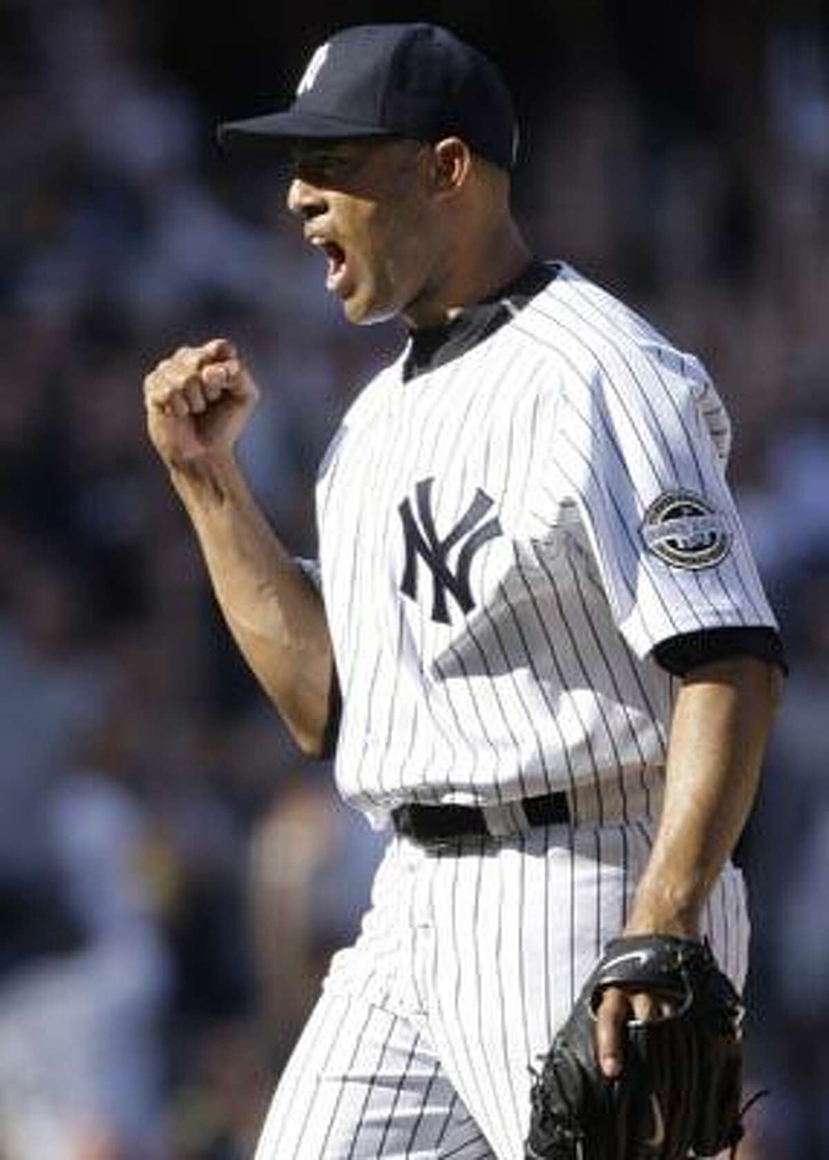 FILE - In this April 17, 2009, file phot, New York Yankees pitcher Mariano Rivera reacts after striking out Cleveland Indians' Mark DeRosa to end the game in a Major League Baseball game in New York. Rivera and the Yankees have finalized their $30 million, two-year contract on Tuesday, Dec. 14, 2010. The 41-year-old closer receives $15 million in each of the next two seasons, with $1.5 million each year deferred with no interest. The deferred money will be paid in $1 million annual installments starting in 2013. (AP Photo/Julie Jacobson, File)