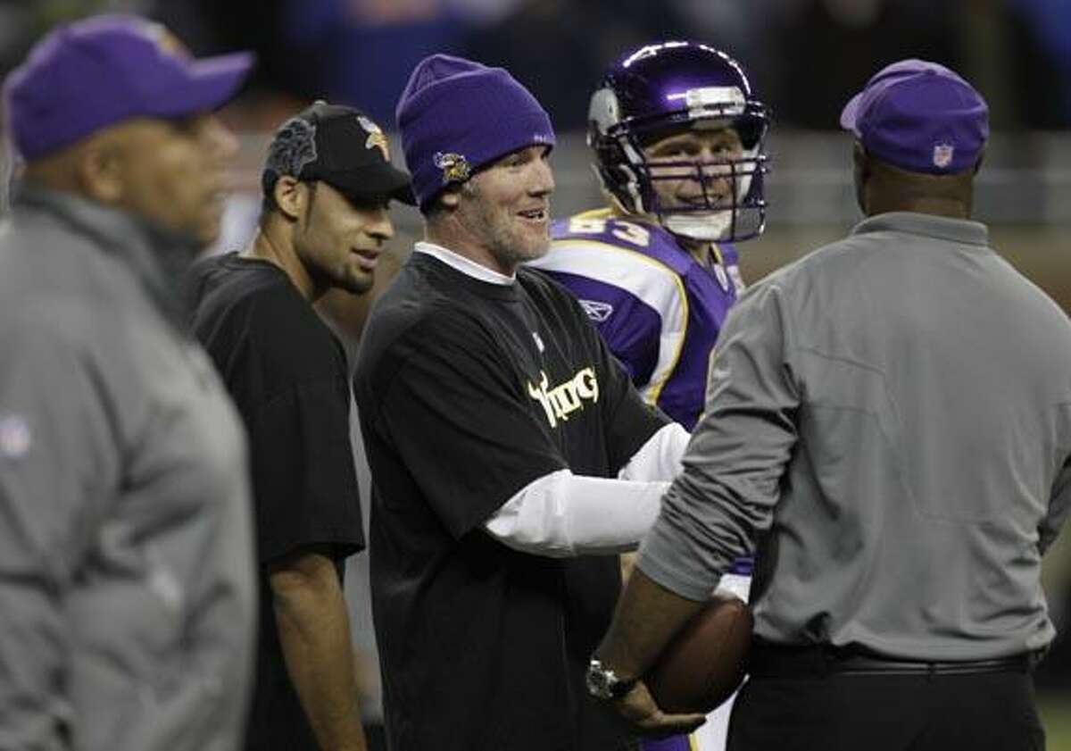 Minnesota Vikings quarterback Brett Favre laughs with teammates during warmups at Ford Field before their NFL football game against the New York Giants in Detroit, Monday, Dec. 13, 2010. Favre is inactive for the game with the Giants, ending his record consecutive starts streak at 297, dating back to 1992. (AP Photo/Paul Sancya)