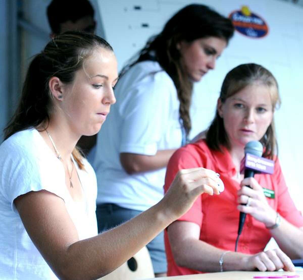 Anastasia Pavlyuchenkova (left) and WTA tour supervisor Melanie Tabb (right) begin the women's draw at the Pilot Pen tennis tournament in New Haven on 8/20/2010. At center is assistant Brittany Allen.Photo by Arnold Gold AG0382B