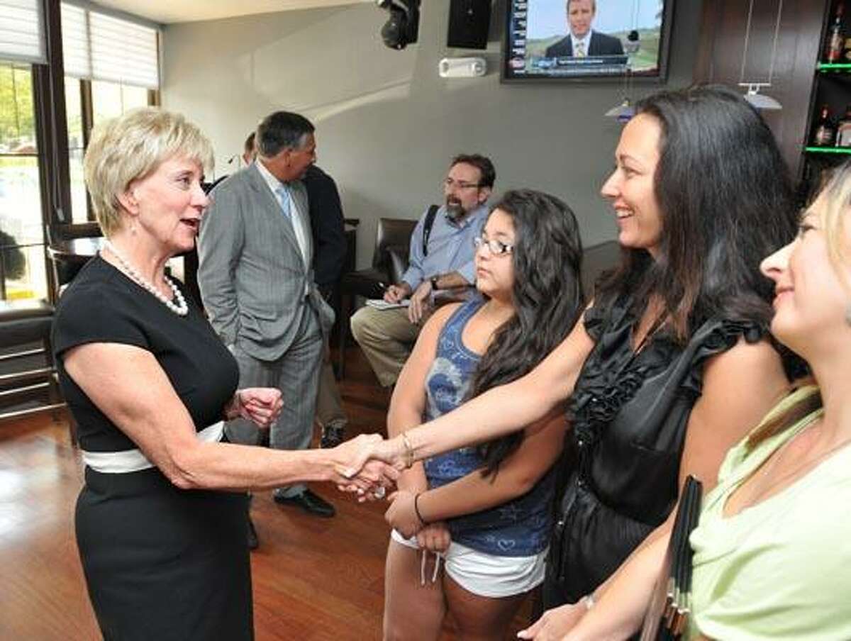 Linda McMahon greets Alison Velez, owner of LuDal's Restaurant in North Haven. On the left is Gabriella Velez (her daughter) and Gina Camarota the restaurant manager. (Peter Casolino/Register)