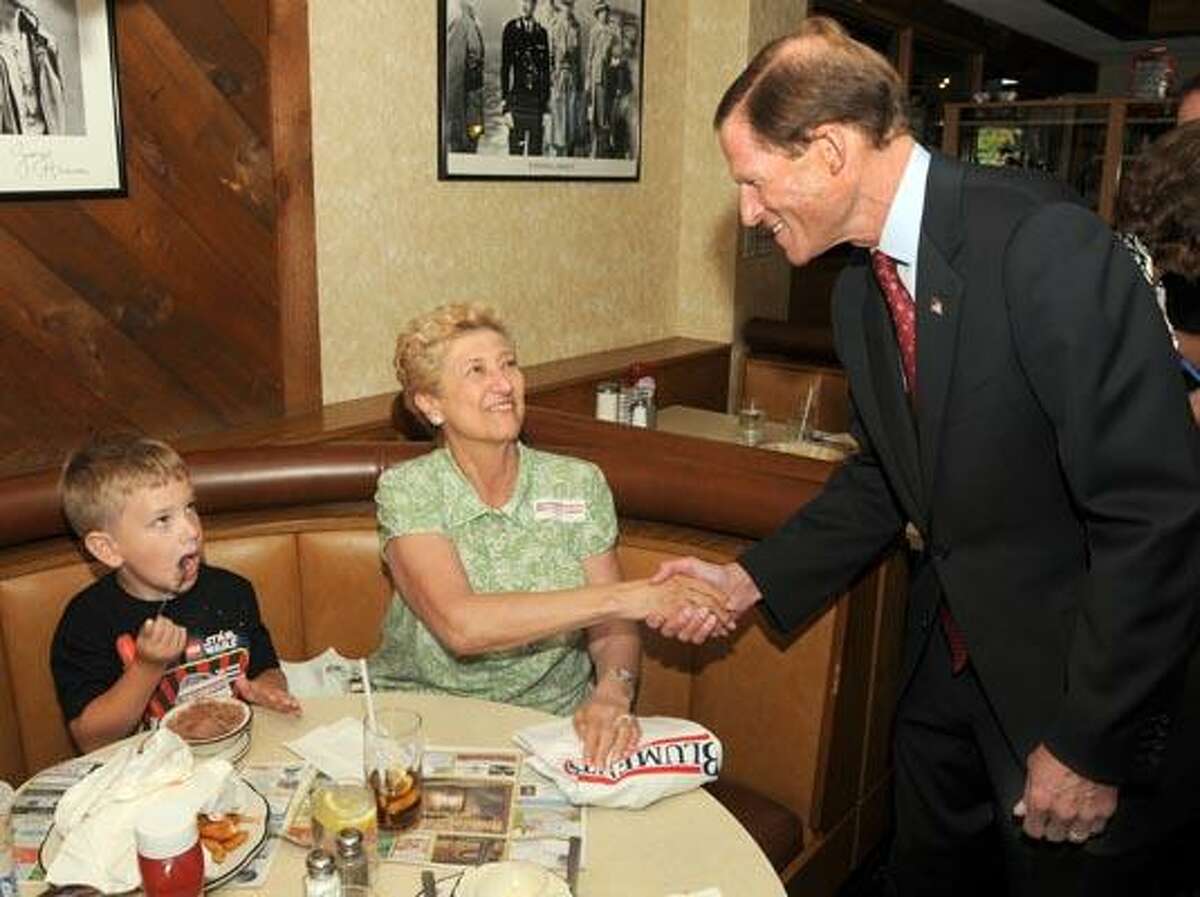 Rae Measom of Hamden center and her grandson Thomas Sperling age 7 of Wallingford meet Attorney General Richard Blumenthal who is running for U.S. Senate during a campaign stop at Hamden's Townhouse Diner (Mara Lavitt/Register)