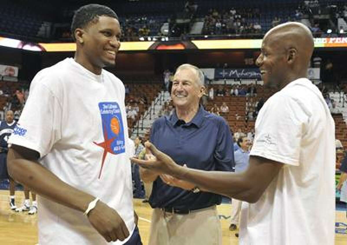 Former UConn players Rudy Gay, left, and Ray Allen talk with their former coach Jim Calhoun prior to the Jim Calhoun Celebrity Classic Charity All-Star basketball game Saturday in Uncasville. (Associated Press/Jessica Hill)