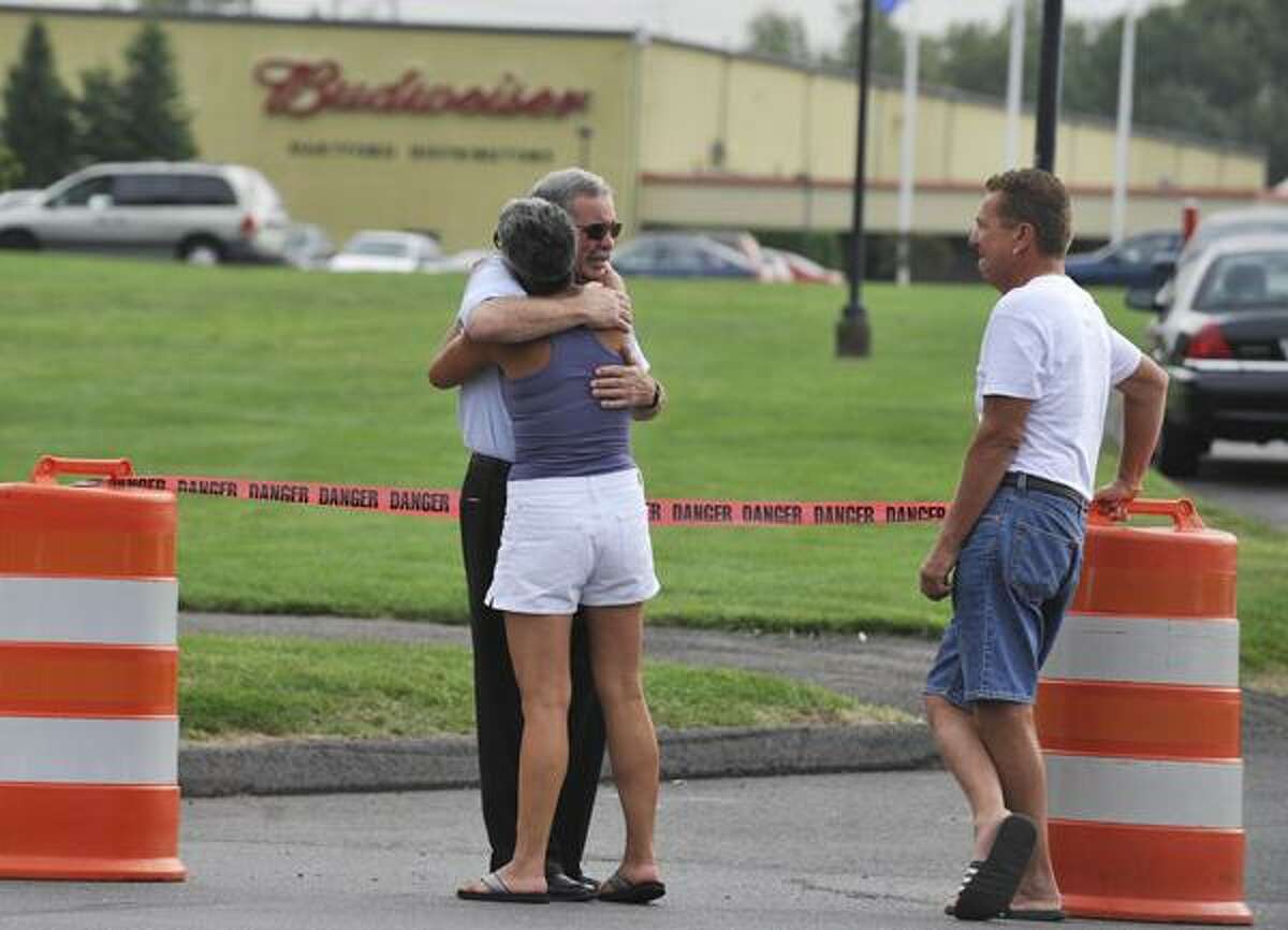 Employees and friends gather outside of Hartford Distributors in Manchester, Conn., Wednesday, Aug. 4, 2010. Omar S. Thornton, a driver for Hartford Distributors, killed eight people, plus himself at the beer distribution company in Connecticut on Tuesday morning. (AP Photo/Jessica Hill)