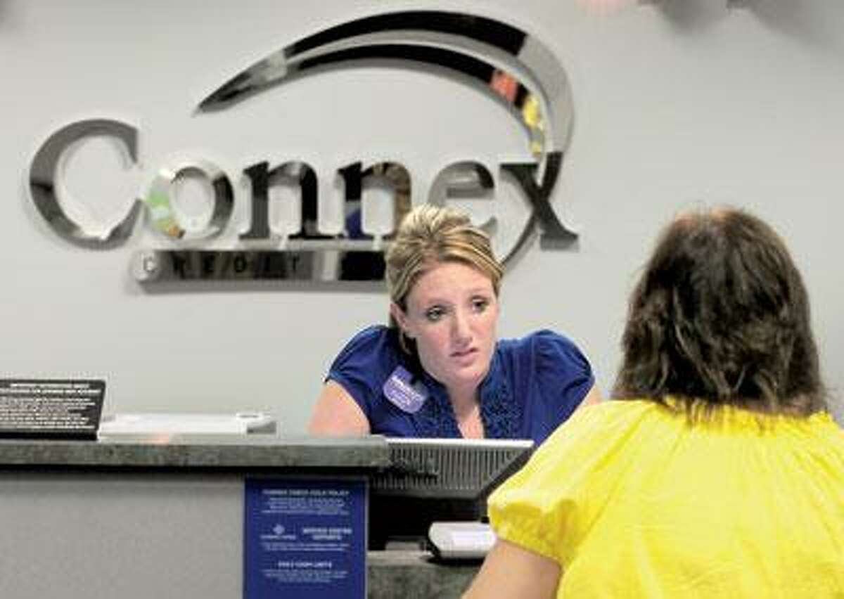 Teller DanaMarie Landino helps a member at Connex Credit Union in Hamden. (Brad Horrigan/Register)