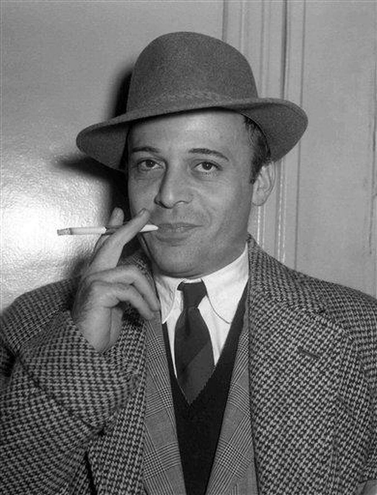 A 1955 file photo shows British actor Herbert Lom at London Airport prior to his departure to Rome, to continue filming 'War and Peace'. The Czech-born actor who starred as Inspector Clouseau's boss in the Pink Panther movies, has died. He was 95. Associated Press