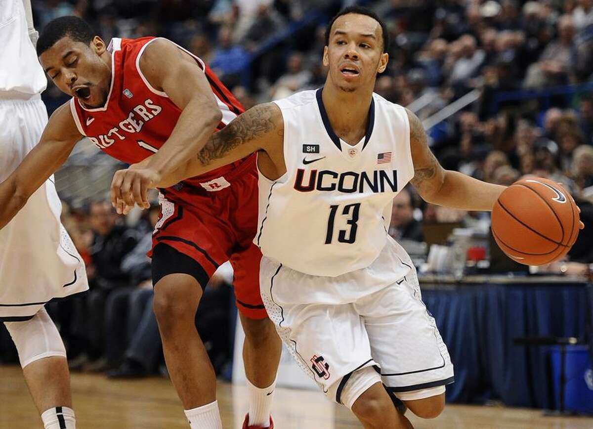 Connecticut's Shabazz Napier (13) drives past Rutgers' Jerome Seagears during the second half of an NCAA college basketball game in Hartford, Conn., Sunday, Jan. 27, 2013. Napier and Seagears were top scorers for their teams with 19 and 21 points respectively. Connecticut won 66-54. (AP Photo/Jessica Hill)