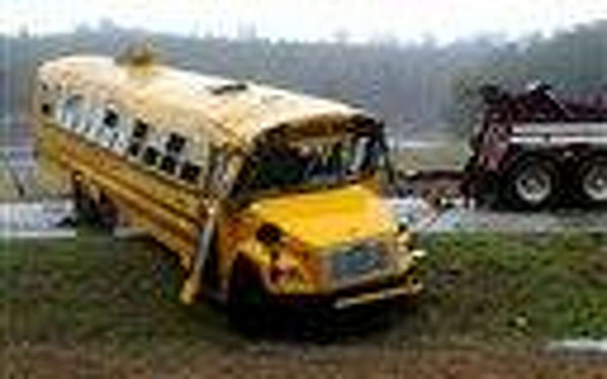 A school bus is uprighted following a wreck on Pike County Road 2243 in Goshen, Ala., Friday. More than 20 students were sent to Troy and Luverne hospitals after the bus overturned in Goshen. Associated Press