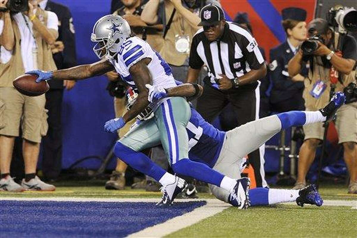 Dallas Cowboys wide receiver Kevin Ogletree (85) scores a touchdown as New York Giants strong safety Kenny Phillips (21) defends during the second half of an NFL football game, Wednesday, Sept. 5, 2012, in East Rutherford, N.J. (AP Photo/Bill Kostroun)