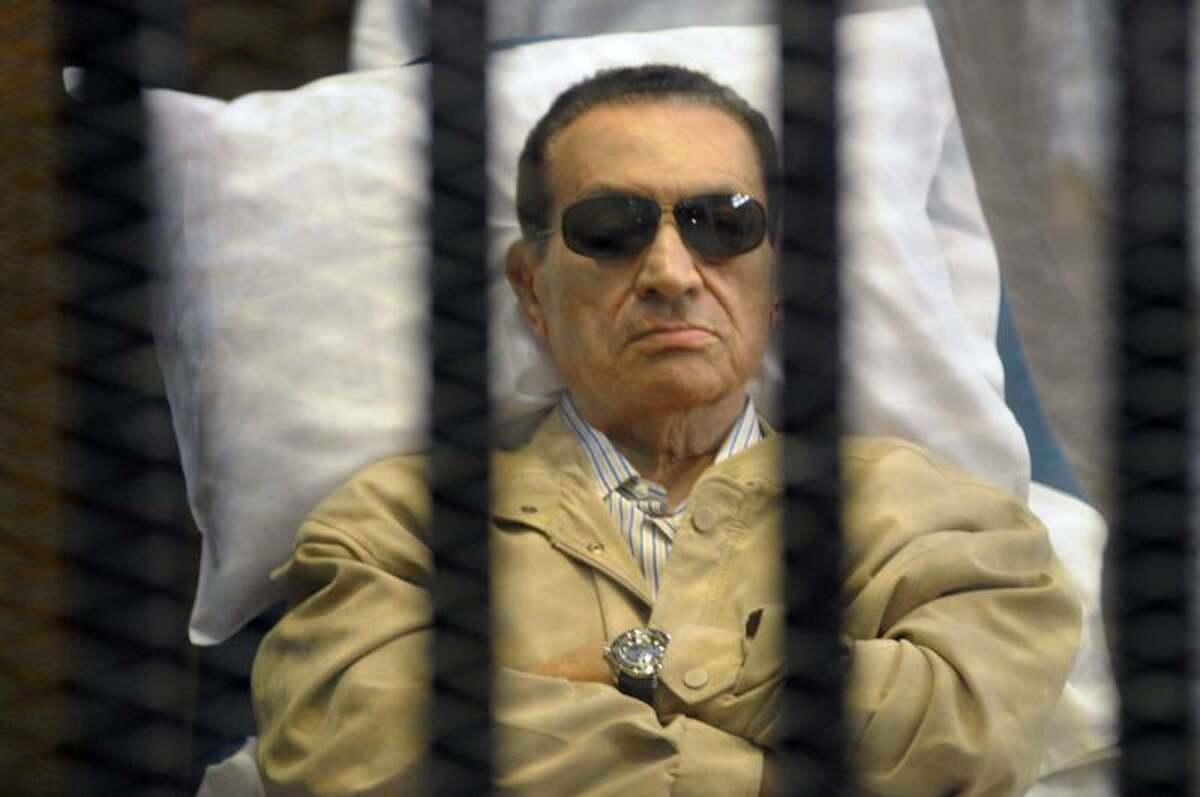 In this Saturday, June 2, 2012, file photo, Egypt's ex-President Hosni Mubarak lays on a gurney inside a barred cage in the police academy courthouse in Cairo, Egypt. An Egyptian prison official says Hosni Mubarak's health has taken a turn to the worst and is likely to be moved out of his prison hospital to a military facility nearby. The official said Tuesday doctors reported that the 84-year old former president has fallen unconscious. He said they have used a defibrillator to restart his heart, and have been administering breathing aid. Associated Press