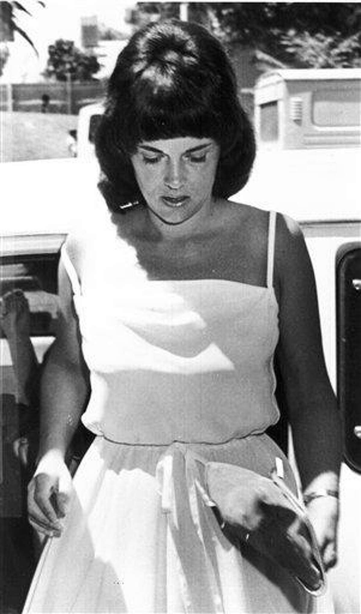 In this 1982 file photo, Lindy Chamberlain leaves a courthouse in Alice Springs, Australia. A coroner found Tuesday that a dingo took Chamberlain's baby, who vanished in the Australian Outback more than 32 years ago in a notorious case that split the nation over suspicions that the infant was murdered. Associated Press