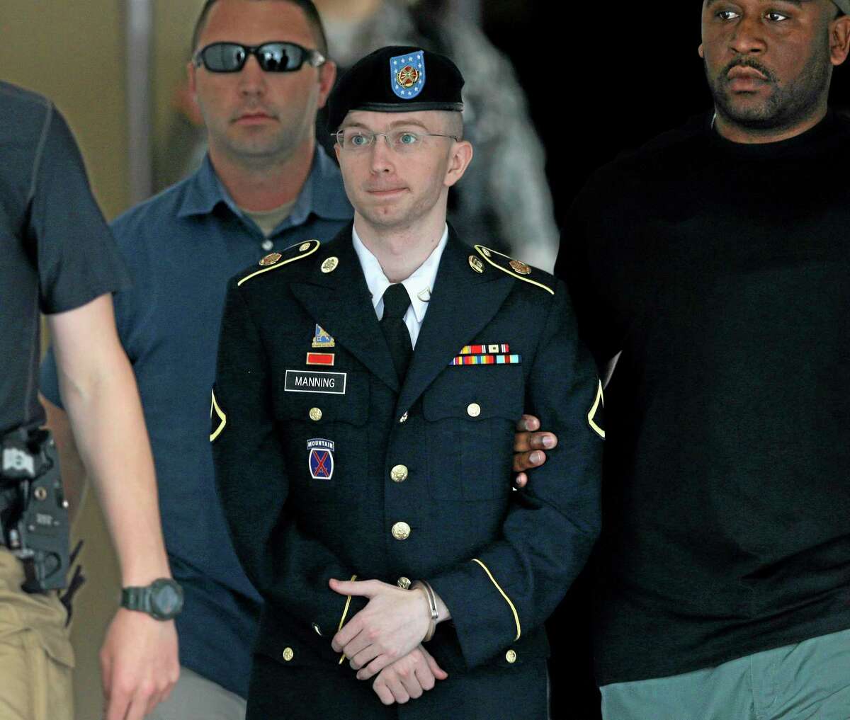 FILE - Army Pfc. Bradley Manning is escorted out of a courthouse in Fort Meade, Md., in a Tuesday, July 30, 2013 file photo, after receiving a verdict in his court martial. Manning's defense team is opening its case at the soldier's sentencing hearing. . (AP Photo/Patrick Semansky, File)