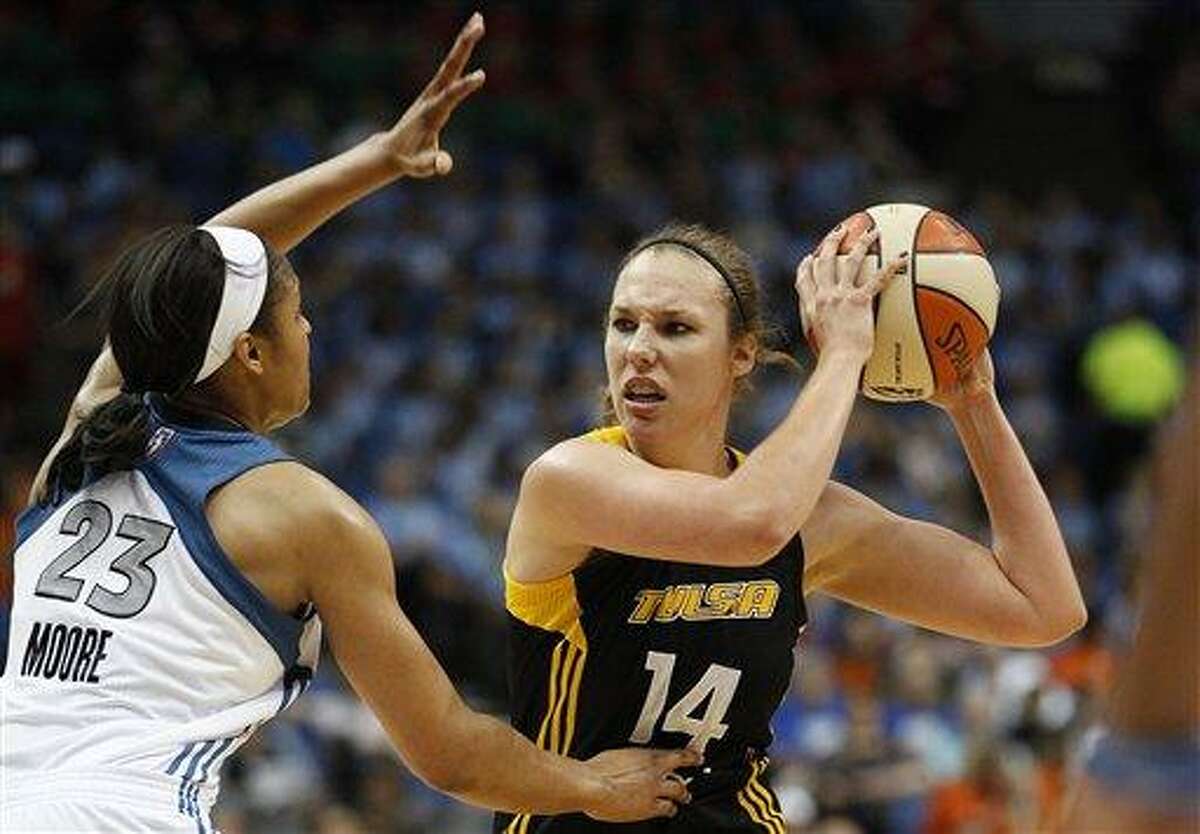 Tulsa Shock forward Kayla Pedersen (14) looks to make a pass against Minnesota Lynx forward Maya Moore (23) during the first half of a WNBA basketball game, Thursday, July 12, 2012, in Minneapolis. (AP Photo/Stacy Bengs)