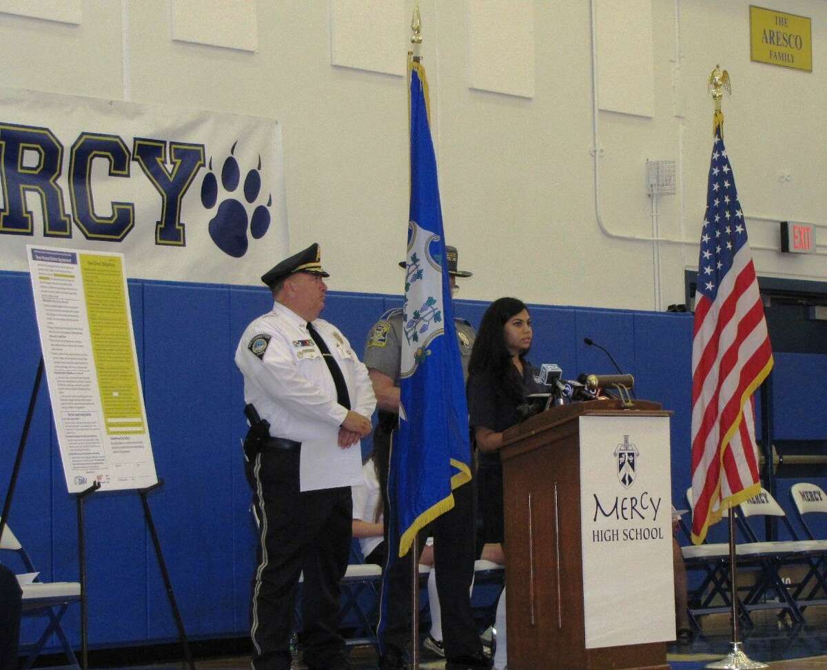 Southington Police Chief John Daly, head of the Connecticut Police Chief's Association, was among the speakers at the Safe Driving Event at Mercy High School. Student Juhi Gupta is at the podium.
