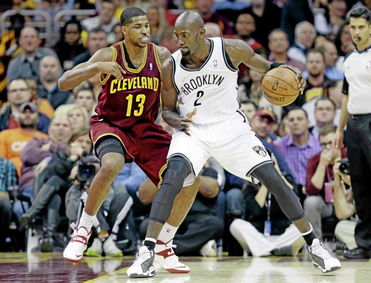 The Nets’ Kevin Garnett (2) tries to get past the Cavaliers’ Tristan Thompson during the fourth quarter of Wednesday’s game in Cleveland. The Cavs beat Brooklyn 98-94.