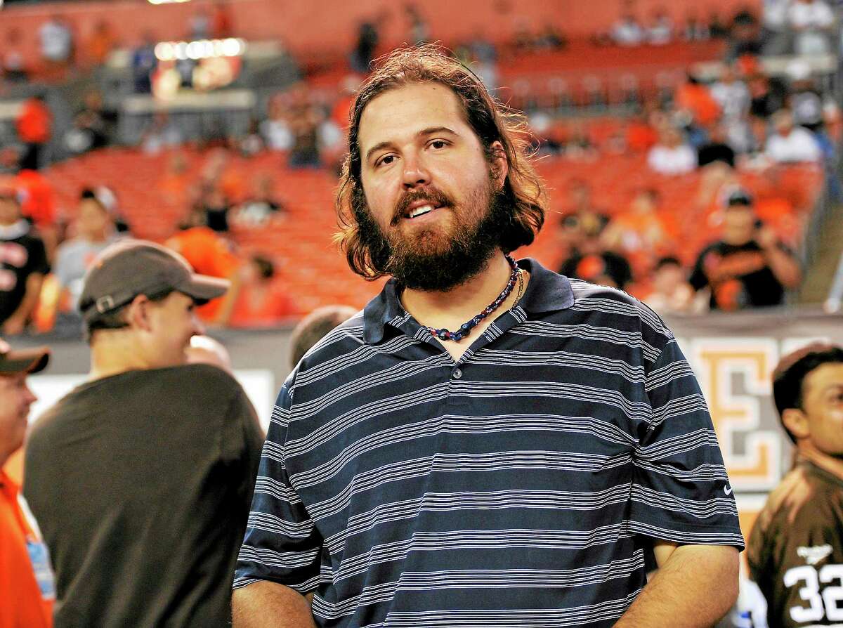The Cleveland Indians have released closer Chris Perez, here watching the Buffalo Bills and Cleveland Browns warm up before their Oct. 3 game in Cleveland.