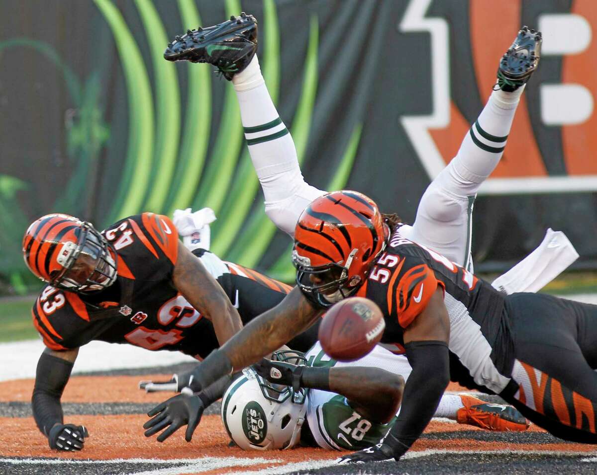 Bengals outside linebacker Vontaze Burfict (55) and strong safety George Iloka (43) break up a pass intended for New York Jets tight end Jeff Cumberland in the end zone during Sunday’s game in Cincinnati.