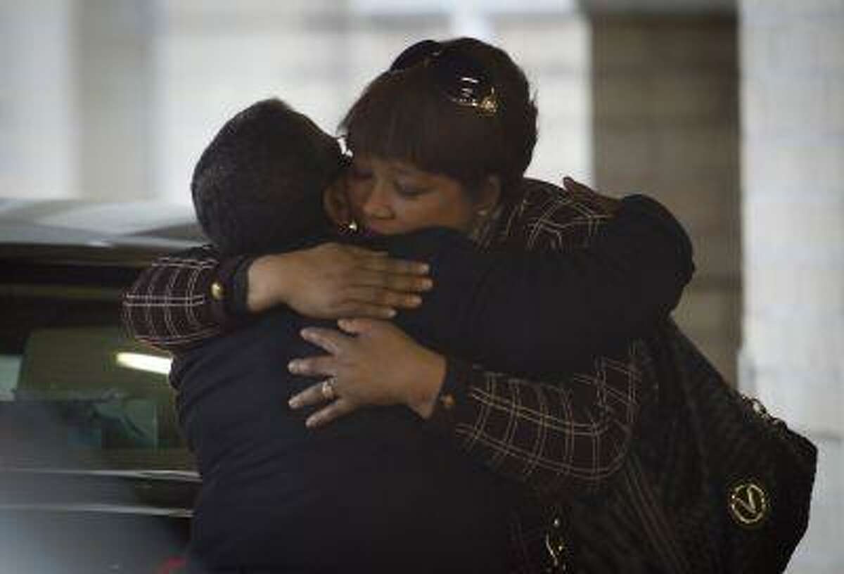 Daughter Zindzi Mandela, right, receives a hug from an unidentified woman, left, as she arrives at the Mediclinic Heart Hospital where former South African President Nelson Mandela is being treated in Pretoria, South Africa Wednesday, June 26, 2013.