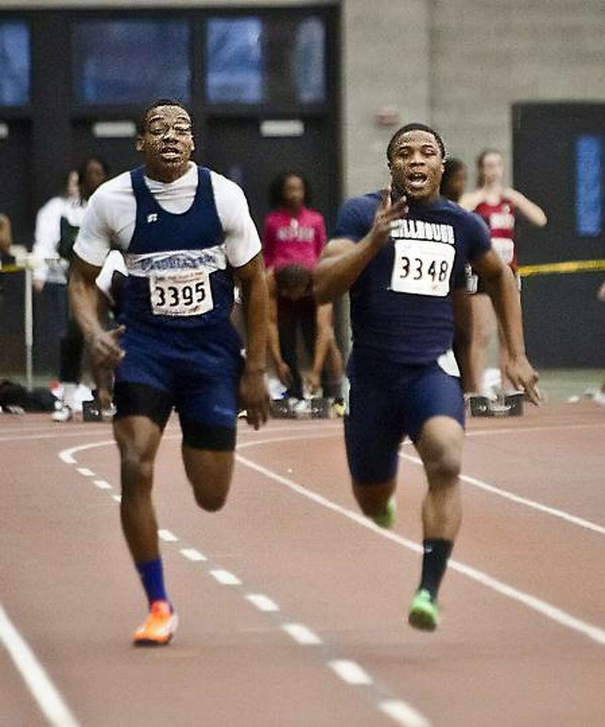 Melanie Stengel/New Haven Register State Open Track and Field Championships / Middletown's Jashane Brown, left, runs alongside winner Harold Cooper Jr. in the 55-meter dash at Tuesday's State Open in New Haven. 2/15/13