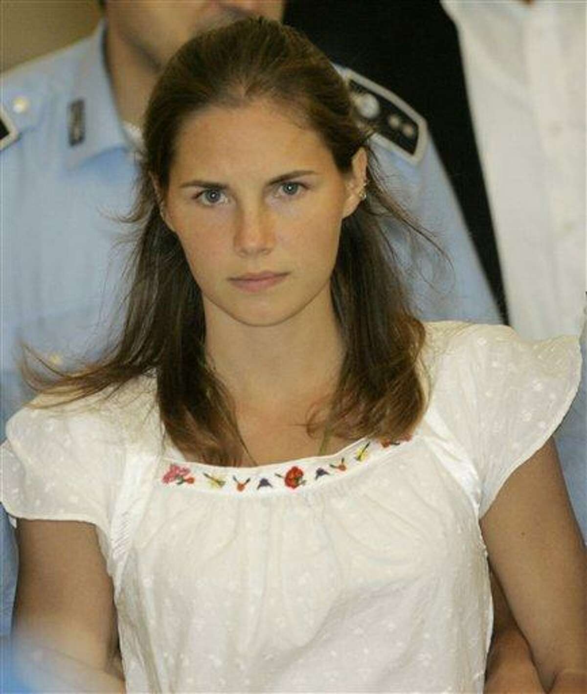 American murder suspect Amanda Knox is escorted by Italian penitentiary police officers from Perugia's court after a hearing in 2008. Italian prosecutors have appealed to Italy's highest criminal court a decision throwing out the murder conviction against Amanda Knox and her former Italian boyfriend in the brutal slaying of a British student. Associated Press file photo