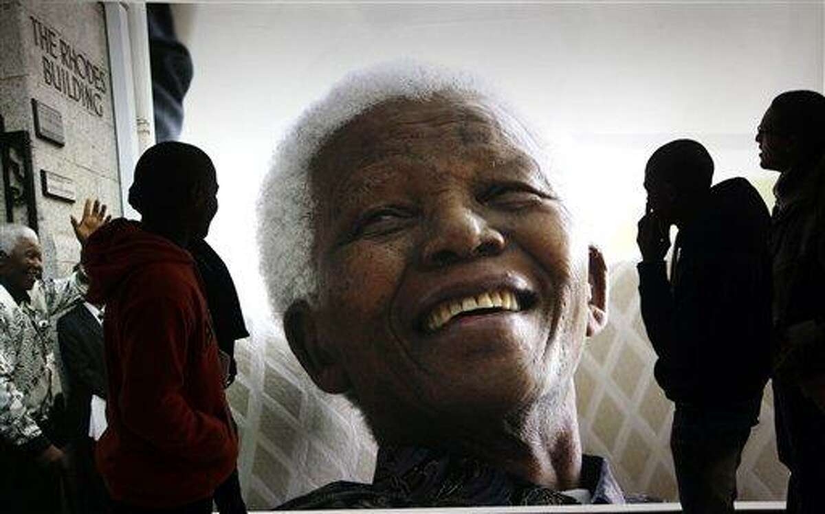 Giant photographs of former president Nelson Mandela are displayed at the Nelson Mandela Legacy Exhibition at the Civic Centre in Cape Town, South Africa, Thursday, June 27, 2013. President Jacob Zuma canceled a trip to Mozambique on Thursday in an indication of heightened concern about Mandela, whose health deteriorated last weekend. (AP Photo)