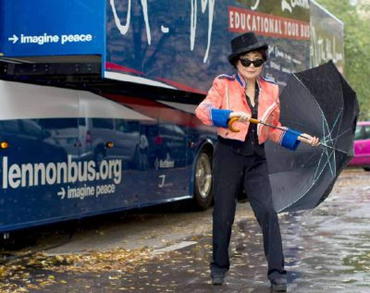 Japanese-US artist Yoko Ono presents the 'John Lennon Educational Tour Bus' in front of John-Lennon-Gymnasium in Berlin, Germany, Tuesday, Oct. 15, 2013. The mobile recording studio offers students the opportunity to record their own piece of music.