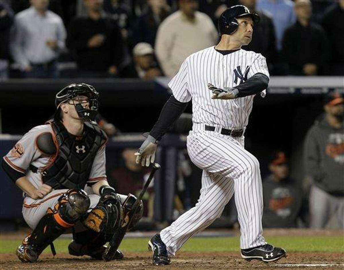 New York Yankees' Raul Ibanez follows through on a home run as Baltimore Orioles catcher Matt Wieters watches during the ninth inning of Game 3 of the American League division baseball series Wednesday, Oct. 10, 2012, in New York. (AP Photo/Kathy Willens)