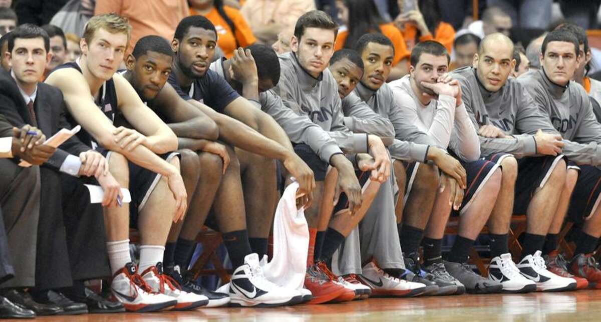 Connecticut players look on during the final seconds of an NCAA college basketball game against Syracuse in Syracuse, N.Y., Saturday, Feb. 11, 2012. Syracuse wonin 85-67 (AP Photo/Kevin Rivoli)