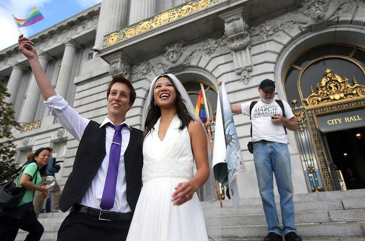 Lisa Dazols, left, and her partner of five years Jenni Chang, of San Francisco, celebrate the Supreme Court's decision on Proposition 8 and the Defense of Marriage Act after a screening at City Hall in San Francisco, Calif., on Wednesday, June 26, 2013. The U.S. Supreme Court dismissed California's Proposition 8 and declared the 1996 Defense of Marriage Act unconstitutional. (Jane Tyska/Bay Area News Group)
