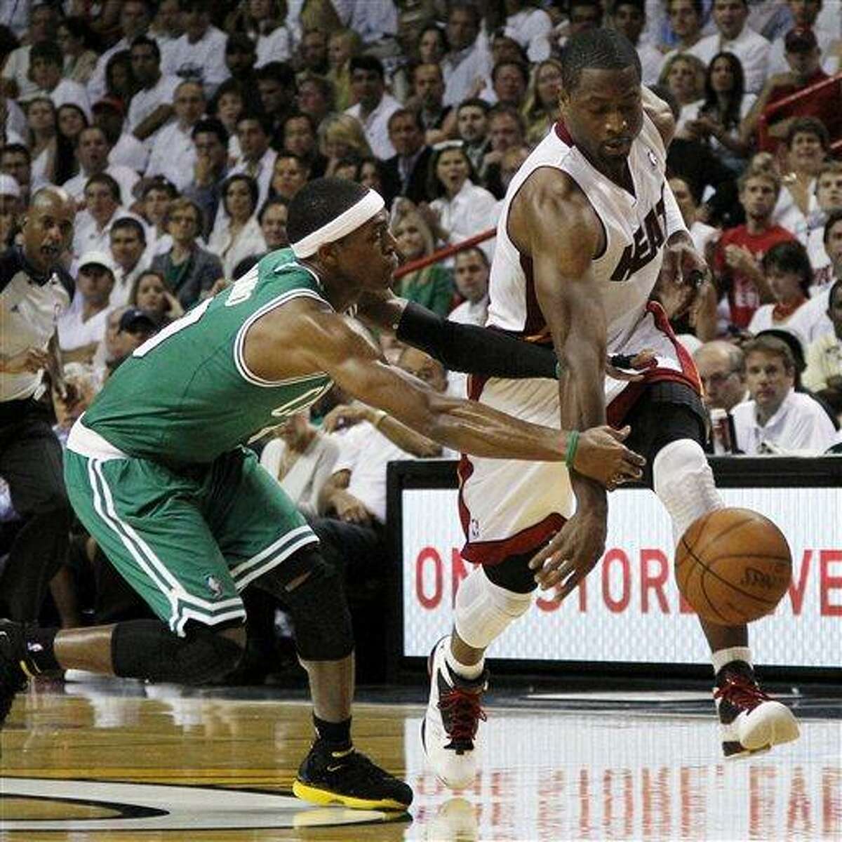 Miami Heat's Dwyane Wade (3) loses the ball as Boston Celtics' Rajon Rondo (9) defends during the first half of Game 5 in their NBA basketball Eastern Conference finals playoffs series, Tuesday, June 5, 2012, in Miami. (AP Photo/Lynne Sladky)