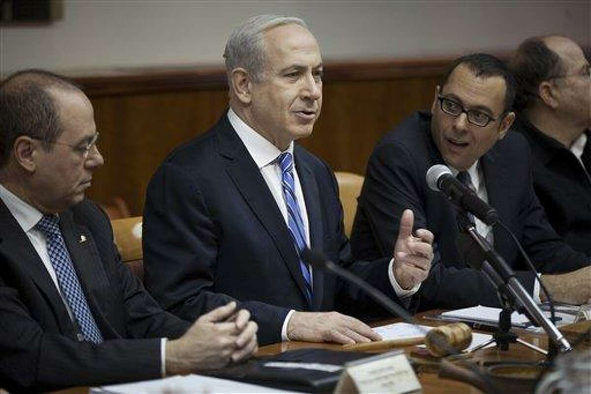 Israeli Prime Minister Benjamin Netanyahu, center, heads the weekly cabinet meeting in his office in Jerusalem. .AP Photo/Uriel Sinai.