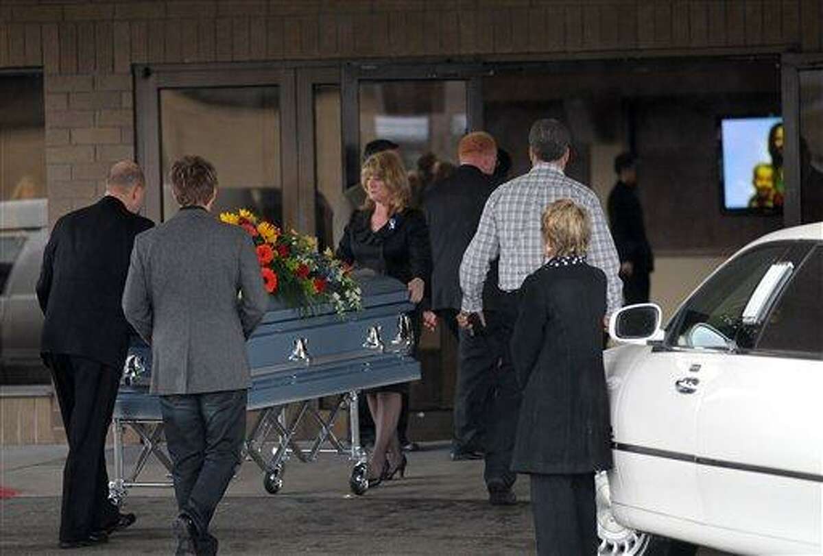A casket with the bodies of Charlie and Braden Powell, ages 7 and 5, is wheeled into Life Center Church in Tacoma Saturday. The family of missing Utah woman Susan Powell is holding a public funeral for her two sons, nearly a week after their father killed them in a gas-fueled blaze. Associated Press