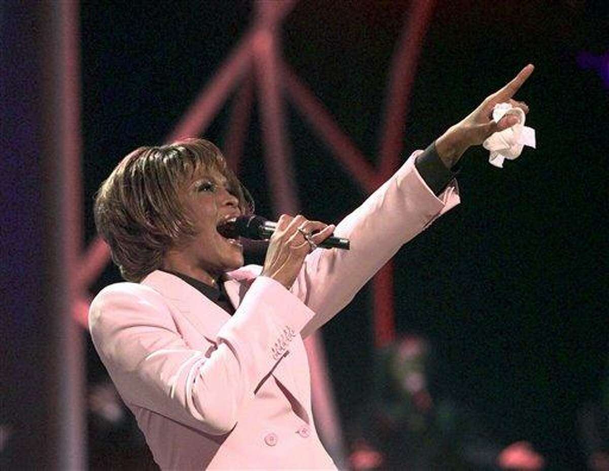 FILE - In this July 11, 1999, file photo, singer Whitney Houston performs "Until You Come Back To Me" during the 26th annual American Music Awards at the Shrine Auditorium in Los Angeles. Publicist Kristen Foster said, Saturday, Feb. 11, 2012, that singer Whitney Houston has died at age 48. (AP Photo/Kevork Djansezian, File)