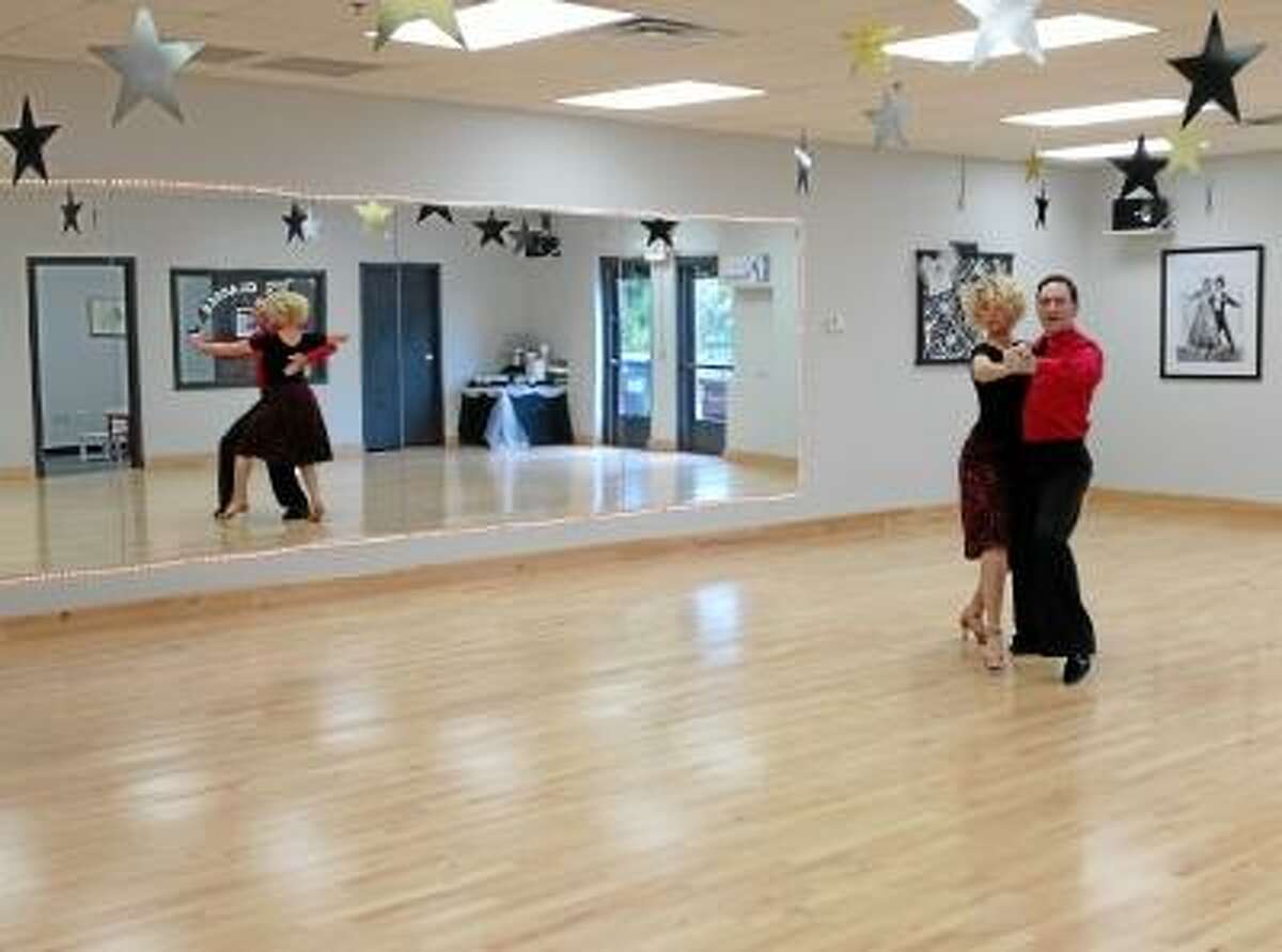 Instructors Chris Martell and Kimber Petrucci demonstrate a classic dance move at the Fred Astaire Dance Stuido in Middletown. Photo by Lauren Sievert/The Middletown Press