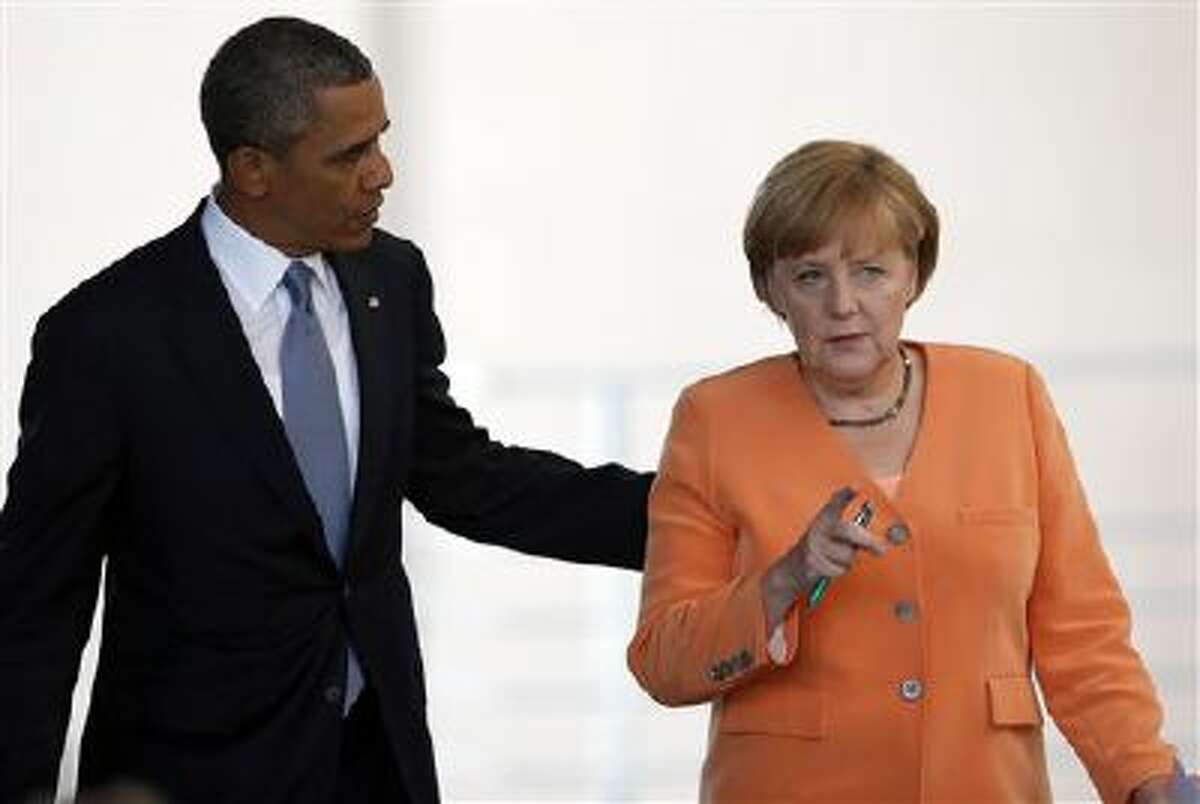 President Barack Obama, left, and German Chancellor Angela Merkel, right, talk after addressing media on June 19.