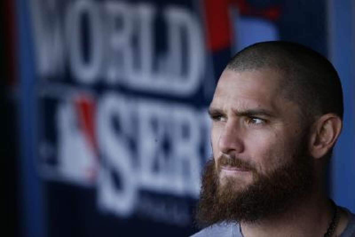 Boston Red Sox's Jonny Gomes looks out of the dugout before Game 5 of the World Series.